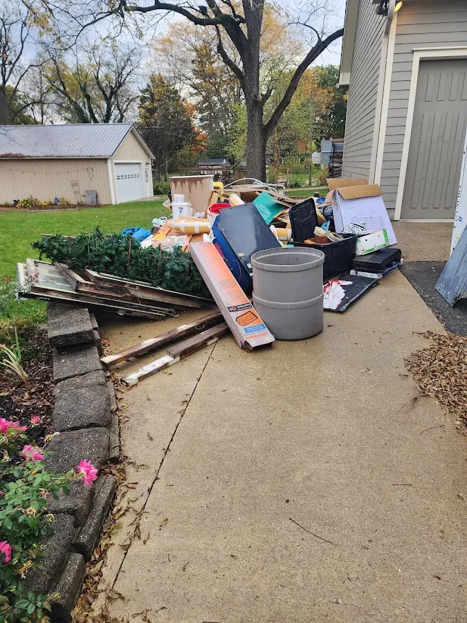 Dumpster being loaded with debris for Estate Cleanout Dumpster Rental in Christiansburg